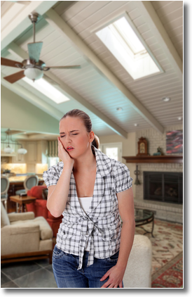 a young lady appears in pain with a toothache